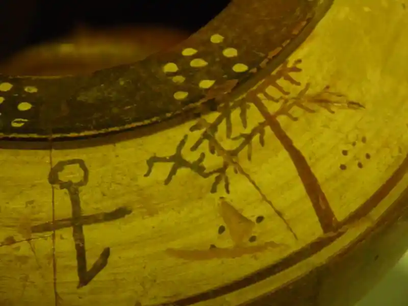 Cross with a circle on top and a tail at the bottom painted on a vase, dated 625-590 BC, located at Archaeological Museum of Izmir